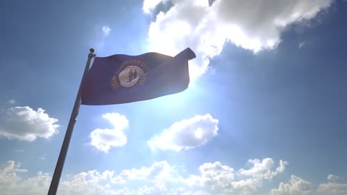 Waving Kentucky State Flag Against Blue Sky with Sun Flare