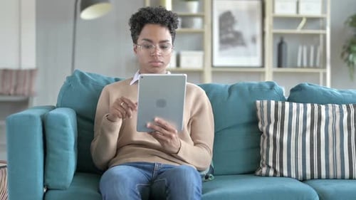 Young Adult Woman Using Tablet Device at Home