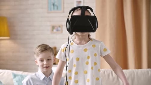 Girl Using VR Headset with Brother in Living Room