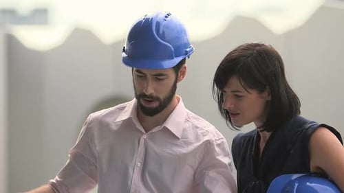 Construction Team Reviewing Building Blueprints