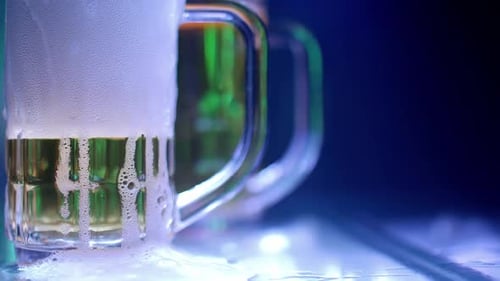 Mug of light beer on the bar counter at a pub party.