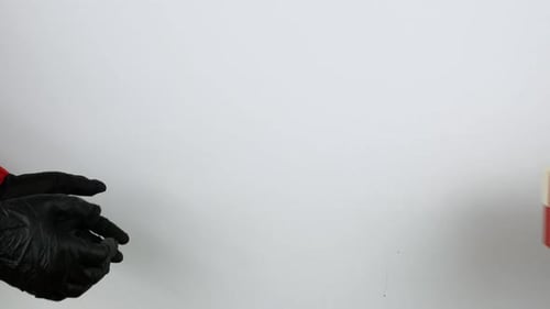 Gloved Hands Exchange a Christmas Present