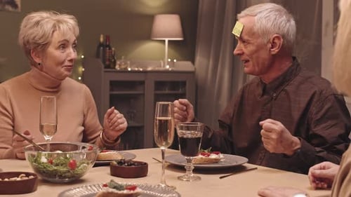 Seniors Playing a Fun Party Game at Dinner
