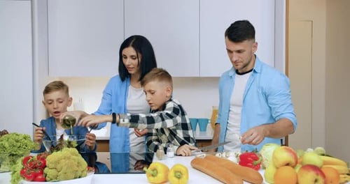 Family Preparing Food Together in Modern Kitchen