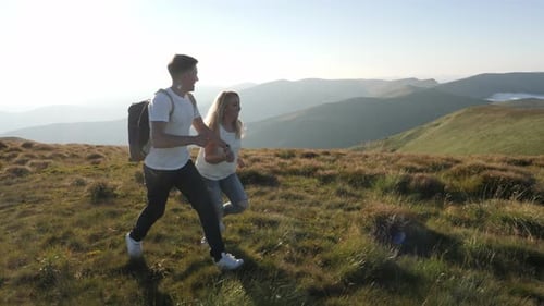 Couple running on a hill