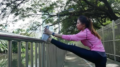 Healthy asian woman exercising at park.woman doing training workout in morning at park after.