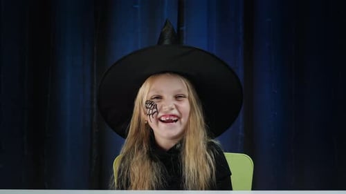 Child Dressed as Witch Smiling for Halloween