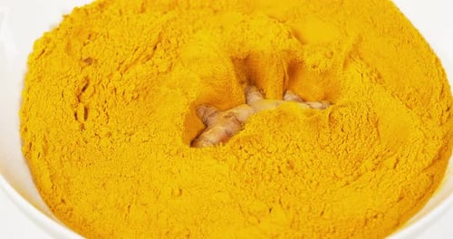 Turmeric, curcuma longa, Root falling on curcuma Powder, Indian Spice, Slow Motion 4K