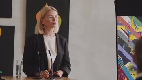 Woman Giving Presentation at Corporate Event
