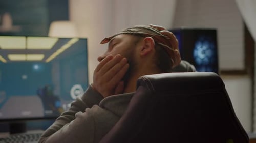 Back View Shot of Professional Gamer Playing in Firstperson Shooter