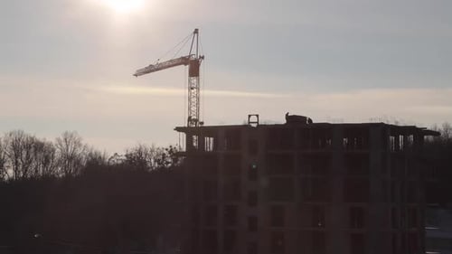 Construction site with big tower crane in time lapse with cloudscape.
