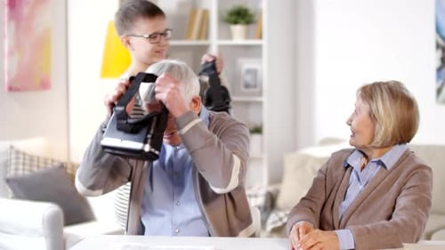Senior Couple Enjoys Virtual Reality with Teen