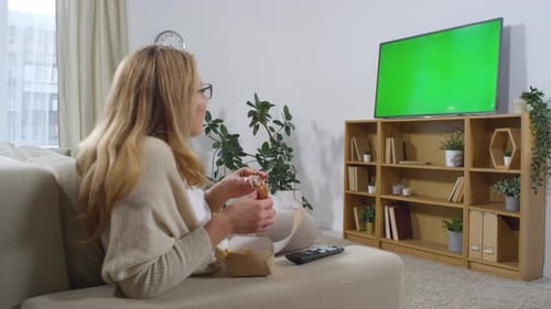 Woman Eating and Watching TV with Green Screen