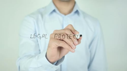 Man Writes Legal Protection on Clear Surface