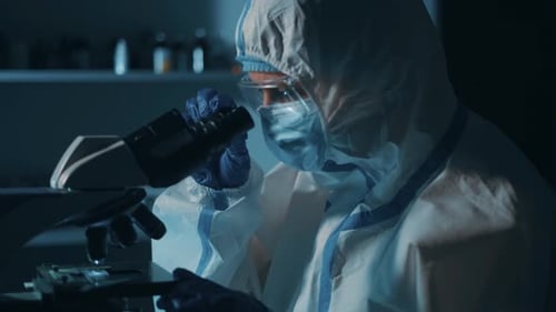 Scientist Working with Microscope in Lab