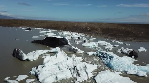 Island. Eisberge in einem Gletschersee. Drohnenflug aus der Luft über die Gletscherlagune.