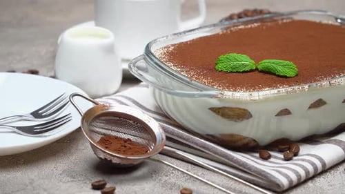 Homemade Tiramisu Garnished with Cocoa Powder and Mint