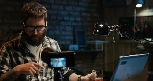Young Man Talking on Camera in a Workshop