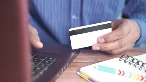 Person Using Credit Card and Laptop