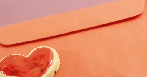 Heart Cookie Resting on Top of an Envelope