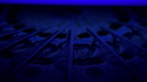 Hundred Dollar Bills Under Ultraviolet Light Slowly Rotates in a Circle
