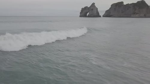 Flying with waves on beautiful beach