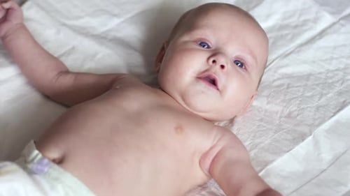 Adorable Infant Lying on a Blanket