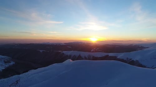 Snowy Mountain Range at Sunrise Aerial View