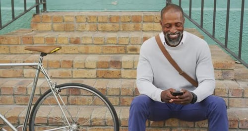 African American man using his phone in the street