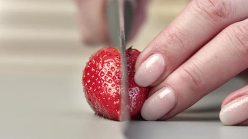 Cutting a Fresh Strawberry in Half with Knife