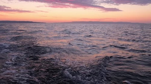 Sun Rises Over Sea Waves at Early Morning