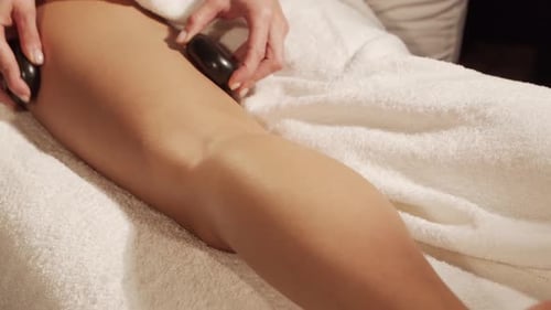 Young, healthy and beautiful woman gets massage therapy in the spa salon.