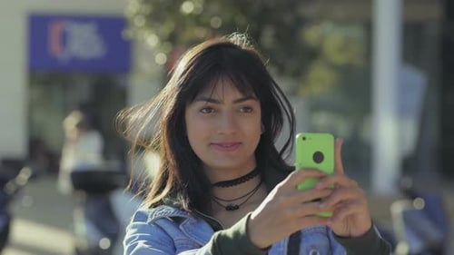 Young Woman Using Smartphone in Urban Environment