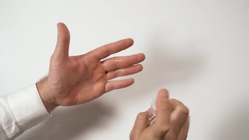 Adult Hands Using Hand Sanitizer for Cleanliness