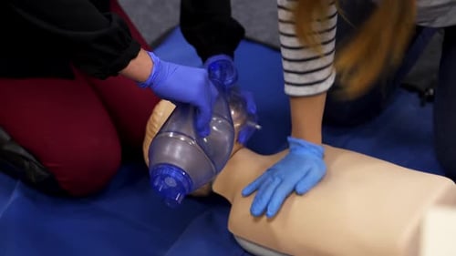 CPR Training on Medical Mannequin with Blue Gloves