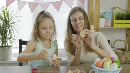 Mother Woman With Daughter Girl Coloring Eggs For The Bright Holiday Easter