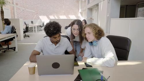 Motivated Young Workers in the Office Explaining the Company's Development Strategy to Smiling Young