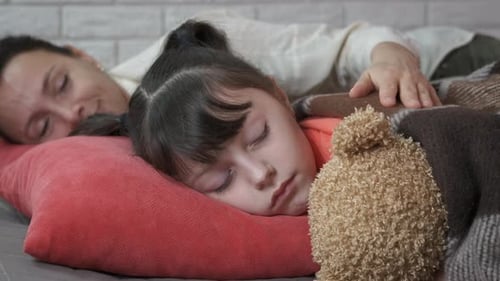 Embracing sleeping child.
