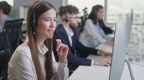 Customer Service Representatives Working in Busy Office