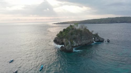 Boats Drifting on the Sea in Nusa Penida Islands, Bali Indonesia and Sun Beaming From Sky