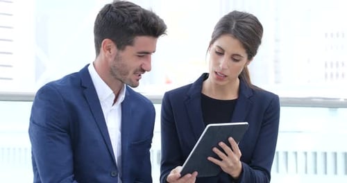 Business Colleagues Looking at Tablet in City