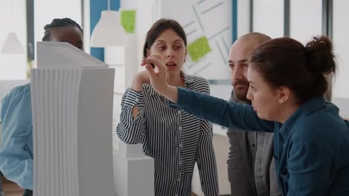 Close Up of Diverse People Working with Building Model to Design Construction Structure