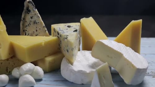 Close Up of Assorted Cheeses on Wooden Table