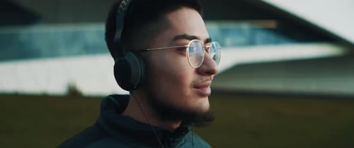 Young Adult with Headphones in Urban Setting