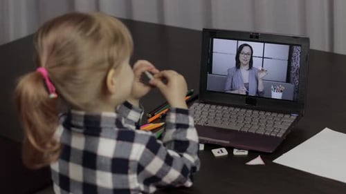 Child Learning with Teacher on Laptop Computer