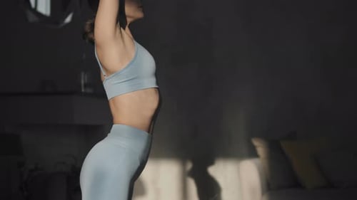 Woman Doing Yoga and Stretching Indoors