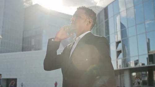 Man in Suit Talking on the Phone Downtown