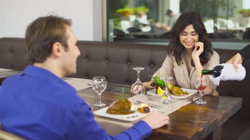 Couple Dining at Restaurant Getting Wine Served