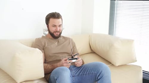 Man Relaxing at Home Playing Video Games