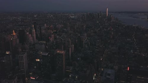 AERIAL: Manhattan Drone Flight at Night with Glowing City Light in New York City
